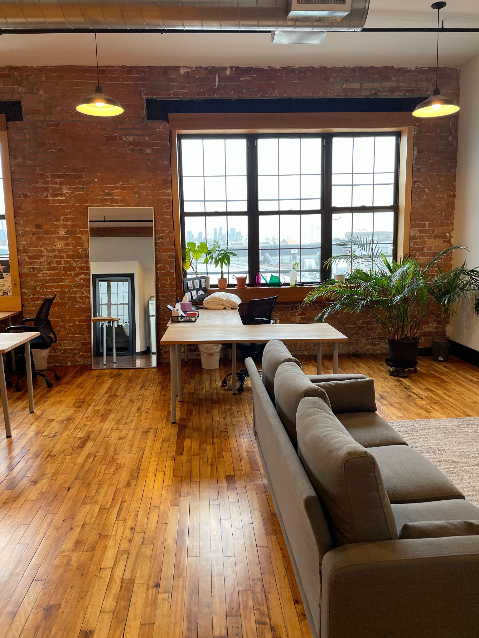 Loft-style workspace with large windows