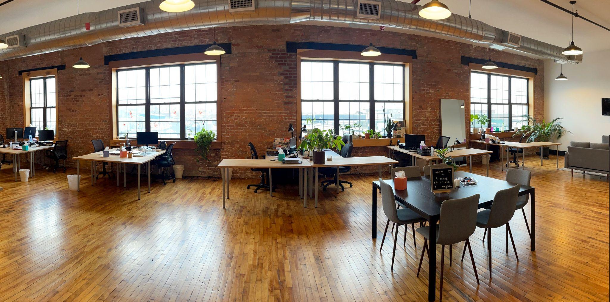 Open office space with exposed brick and hardwood floors