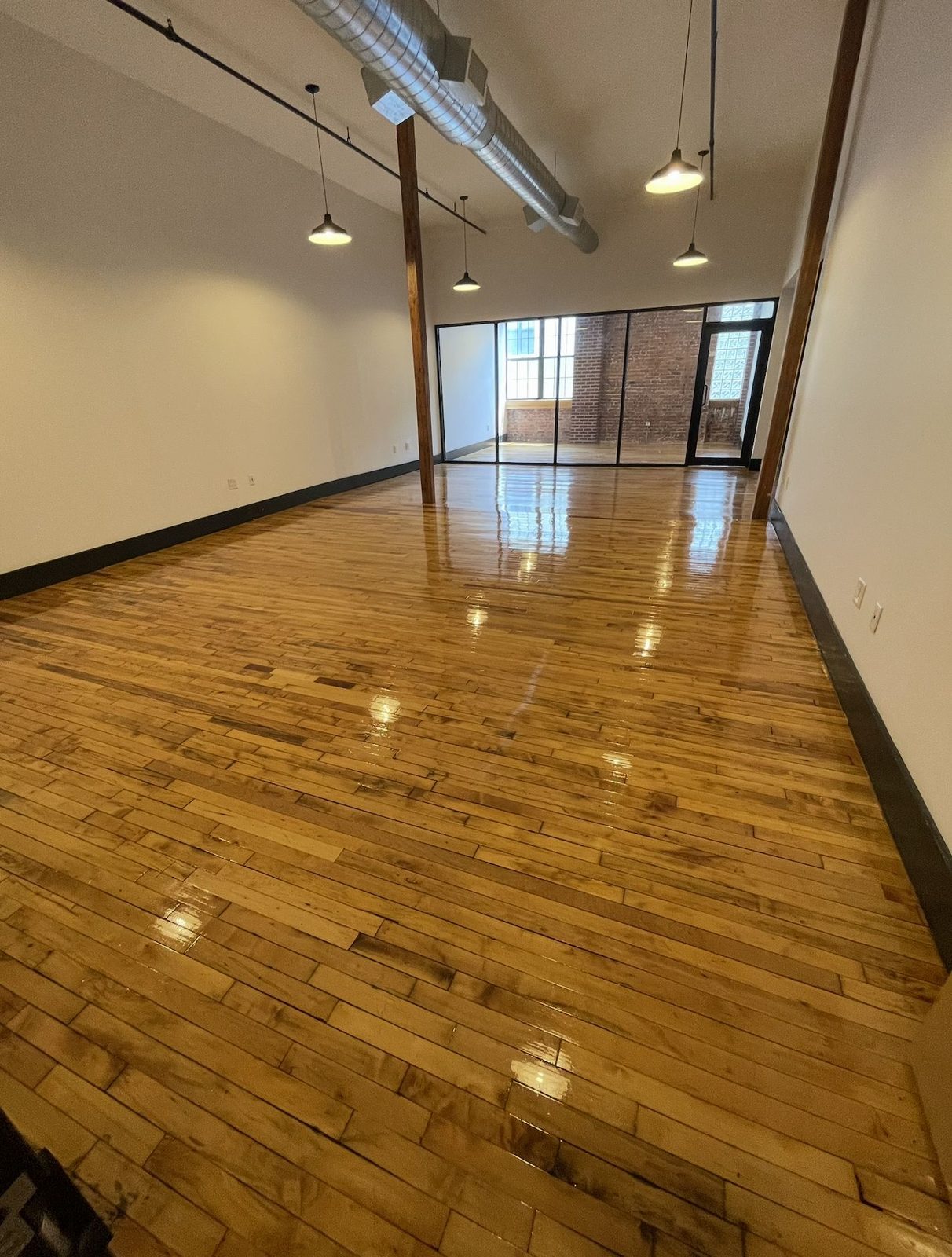 Unit 420/424 looking toward the glass-partitioned area with high ceilings